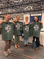 4 people holding FlowCam plankton t-shirts