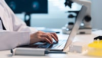Hands typing at keyboard in lab