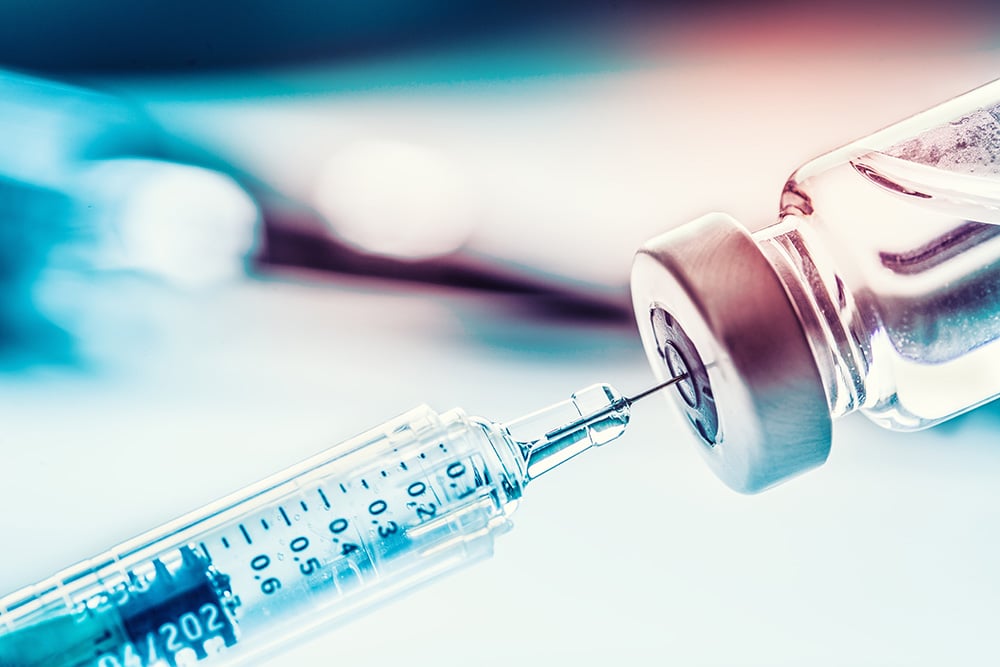 close up of syringe and vial